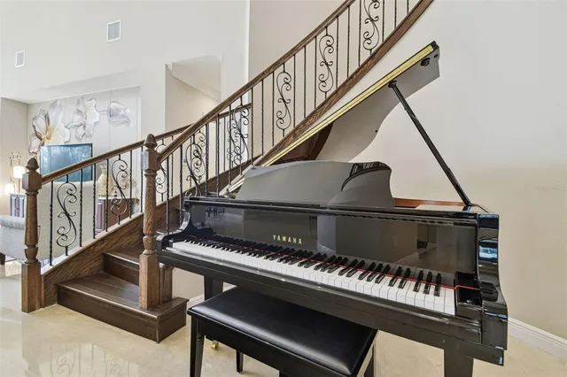 a living room with furniture a flat screen tv and a large window
