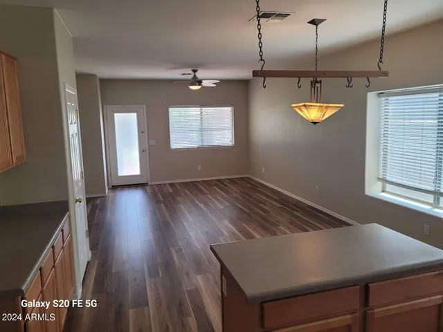 a view of a room with wooden floor and window