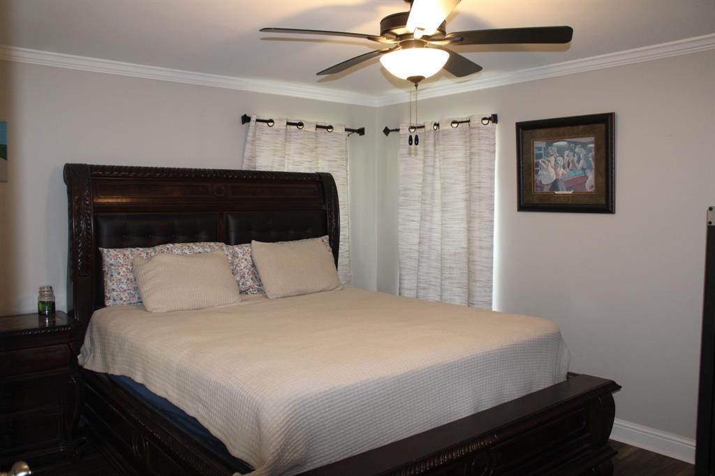 2693 Rhoda Road Shreveport, LA 71119 - Photo 12 of 39 a bedroom with a bed and a chandelier