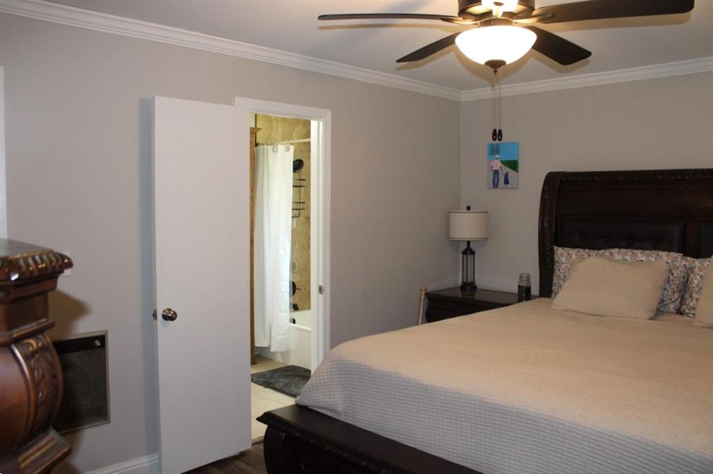 2693 Rhoda Road Shreveport, LA 71119 - Photo 15 of 39 a bedroom with a bed and a chandelier