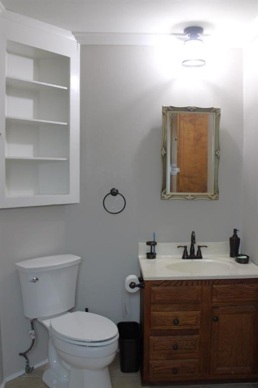 2693 Rhoda Road Shreveport, LA 71119 - Photo 16 of 35 a bathroom with a toilet a sink a vanity and mirror