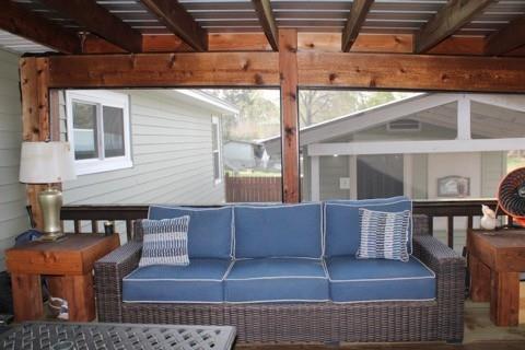 2693 Rhoda Road Shreveport, LA 71119 - Photo 24 of 39 a view of a patio with couches chairs and wooden floor