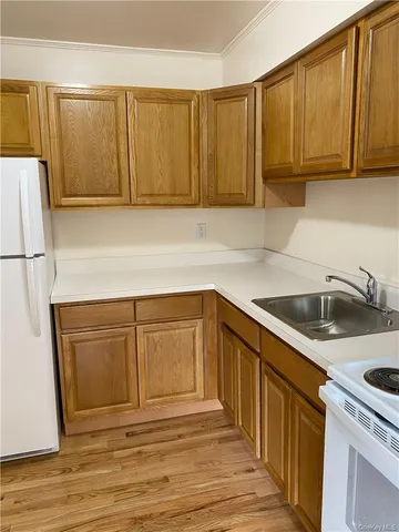 a kitchen with granite countertop cabinets stainless steel appliances and sink