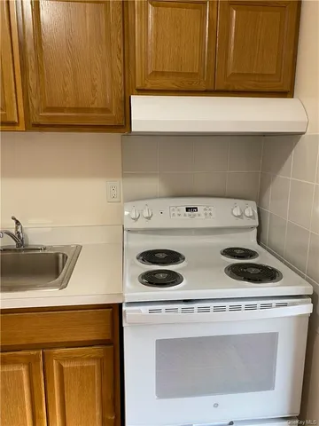 a kitchen with a stove and a sink