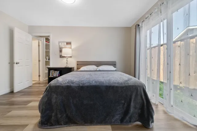 a bedroom with a bed and a window