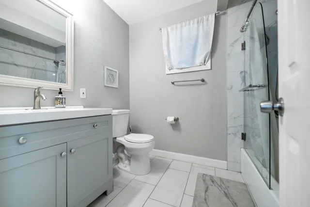 a bathroom with a toilet sink and a mirror