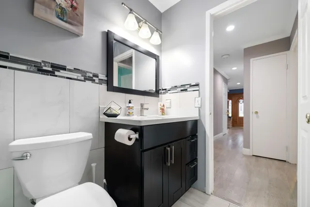 a bathroom with a sink a toilet and mirror