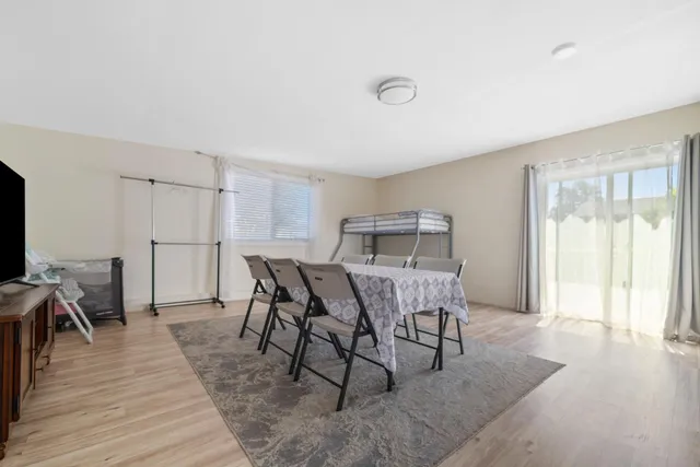 a view of a dining room with furniture and wooden floor