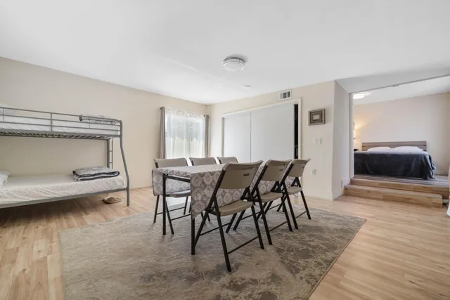 a view of a dining room with furniture and wooden floor