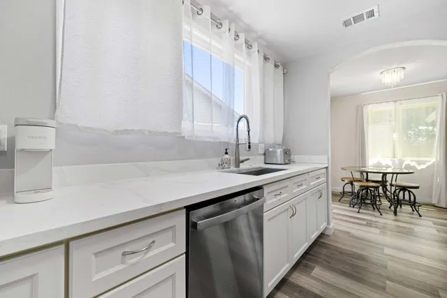 a kitchen with a sink cabinets and window