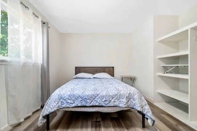 a bedroom with a bed and a window