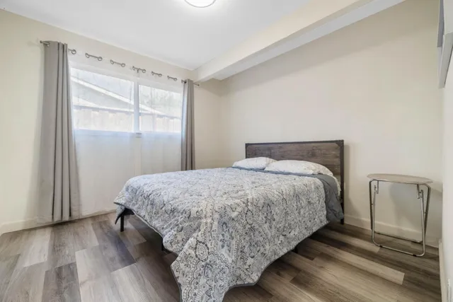 a bedroom with a bed and a mirror