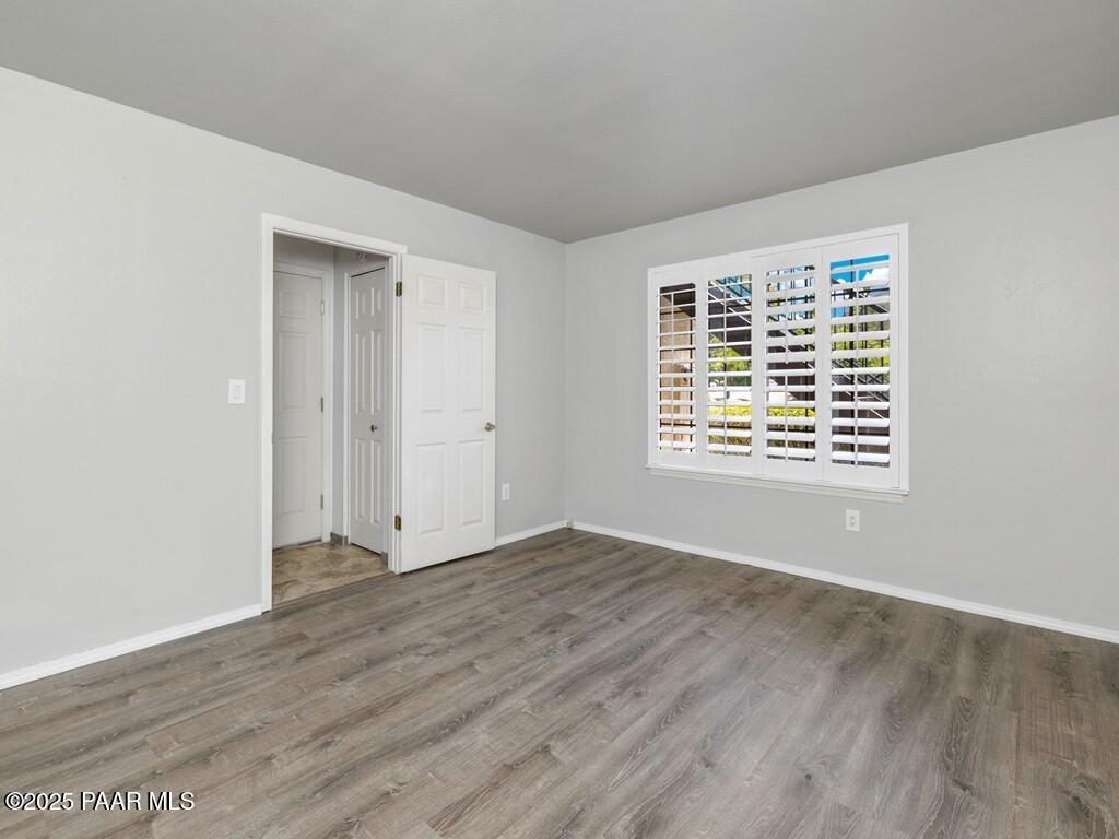 1034 Bunker Place Dewey, AZ 86327 - Photo 15 of 17 an empty room with wooden floor and a window