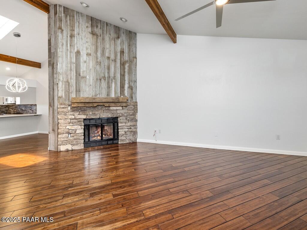1034 Bunker Place Dewey, AZ 86327 - Photo 6 of 17 a view of a livingroom with wooden floor and a fireplace