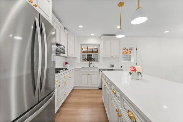 a kitchen with a sink cabinets and window