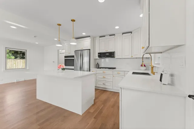 a kitchen with cabinets a sink and appliances