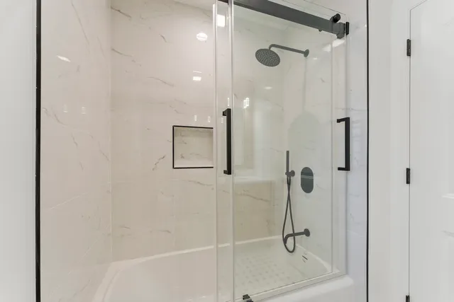 a bathroom with a glass shower door