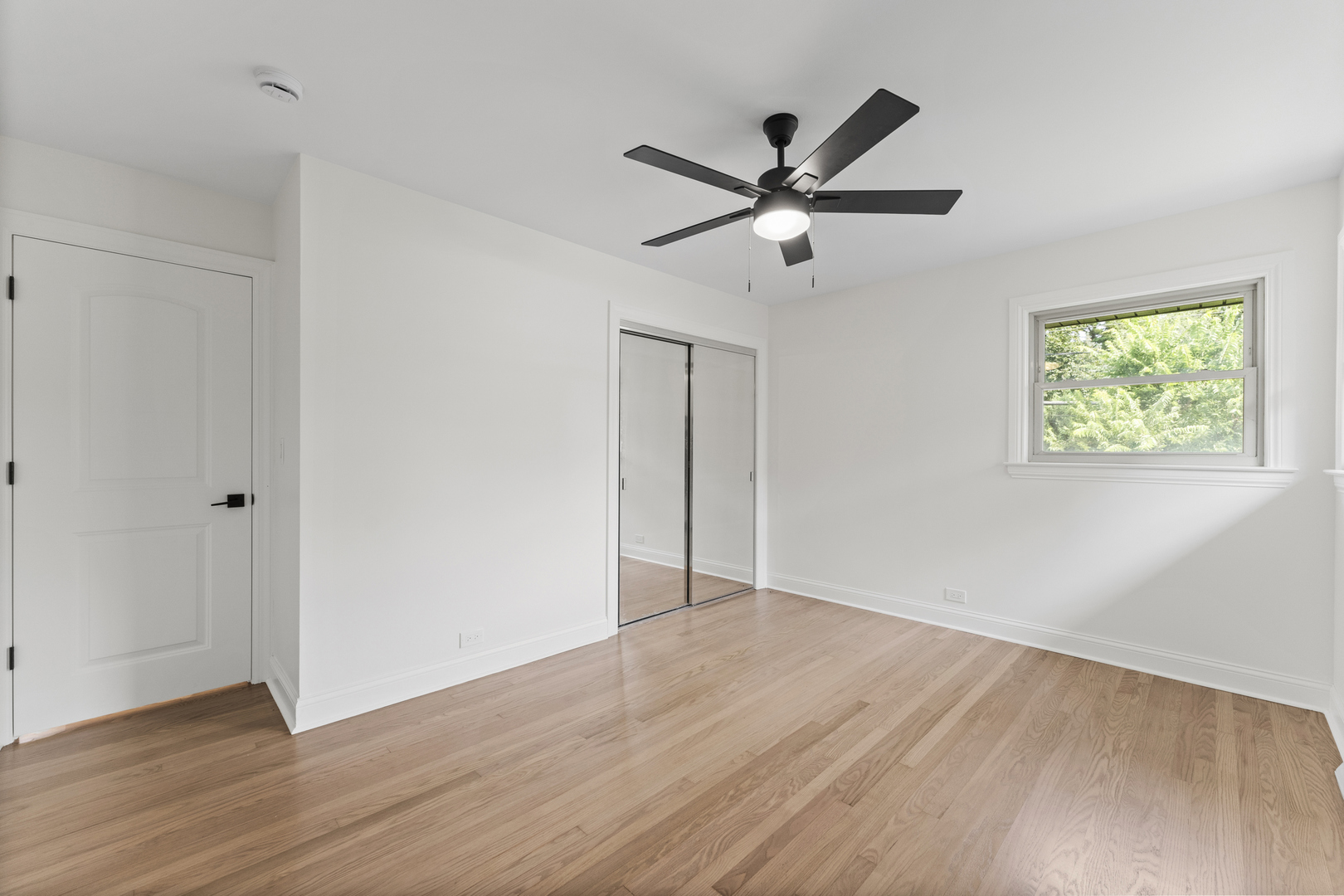 208 47th Street Western Springs, IL 60558 - Photo 22 of 53 a view of an empty room with wooden floor and a window