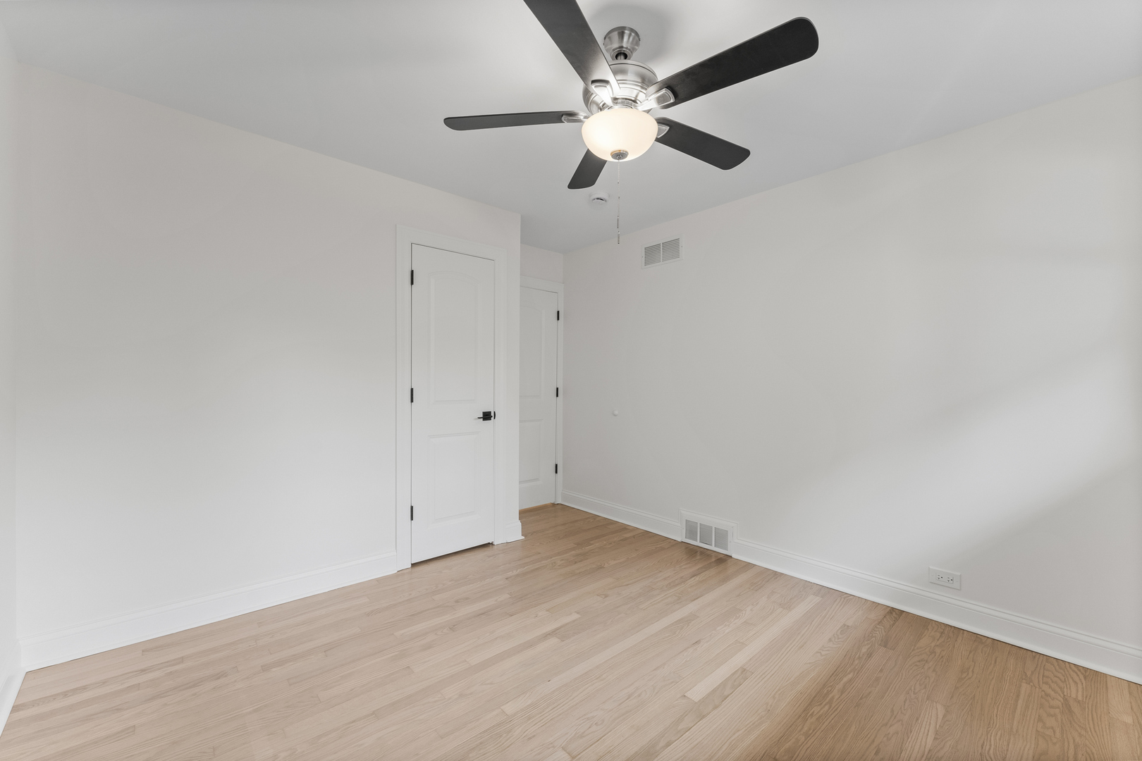 208 47th Street Western Springs, IL 60558 - Photo 29 of 53 an empty room with a ceiling fan and wooden floor