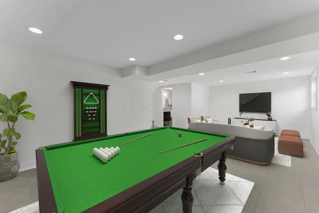 a room with pool table and a flat screen tv