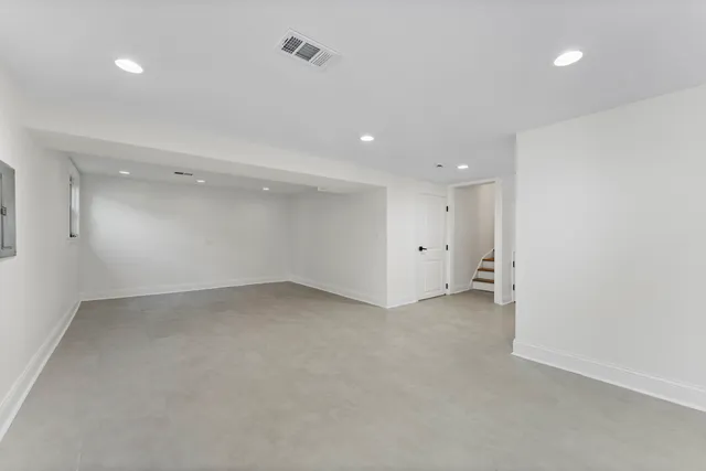 an empty room with windows and outdoor view