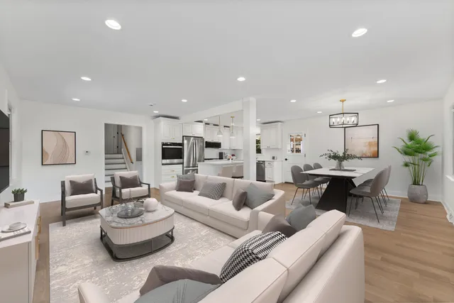 a living room with furniture and view of kitchen