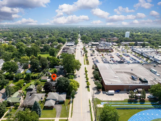 an aerial view of residential houses with outdoor space and trees