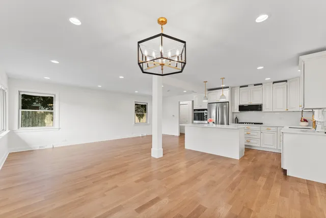 a view of kitchen with cabinets and wooden floor