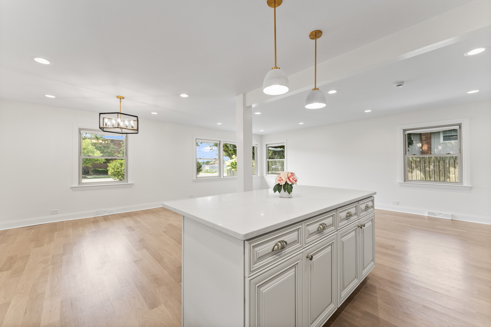 208 47th Street Western Springs, IL 60558 - Photo 8 of 53 a kitchen with kitchen island a sink dishwasher a stove and a dining table with wooden floor