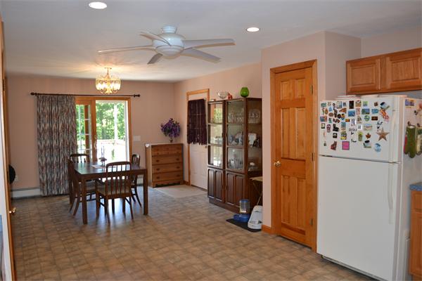 75 Irish Lane Rutland, MA 01543 - Photo 6 of 30 a kitchen with refrigerator a dining table and chairs