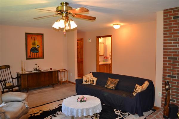 75 Irish Lane Rutland, MA 01543 - Photo 10 of 30 a living room with furniture and a chandelier