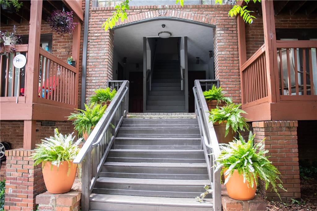 a front view of a house with potted plants