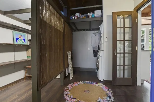 a very nice looking room with a large window and wooden floor