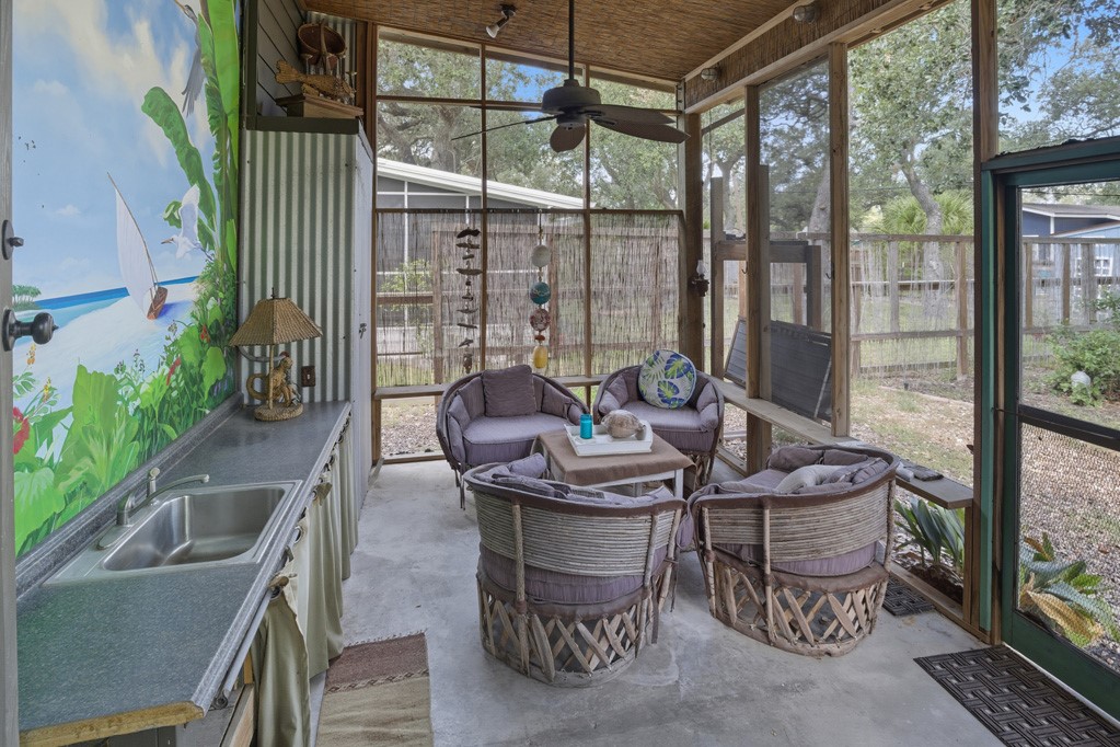 1908 Glass Avenue Rockport, TX 78382 - Photo 23 of 40 a view of a patio with a table chairs and a potted plant