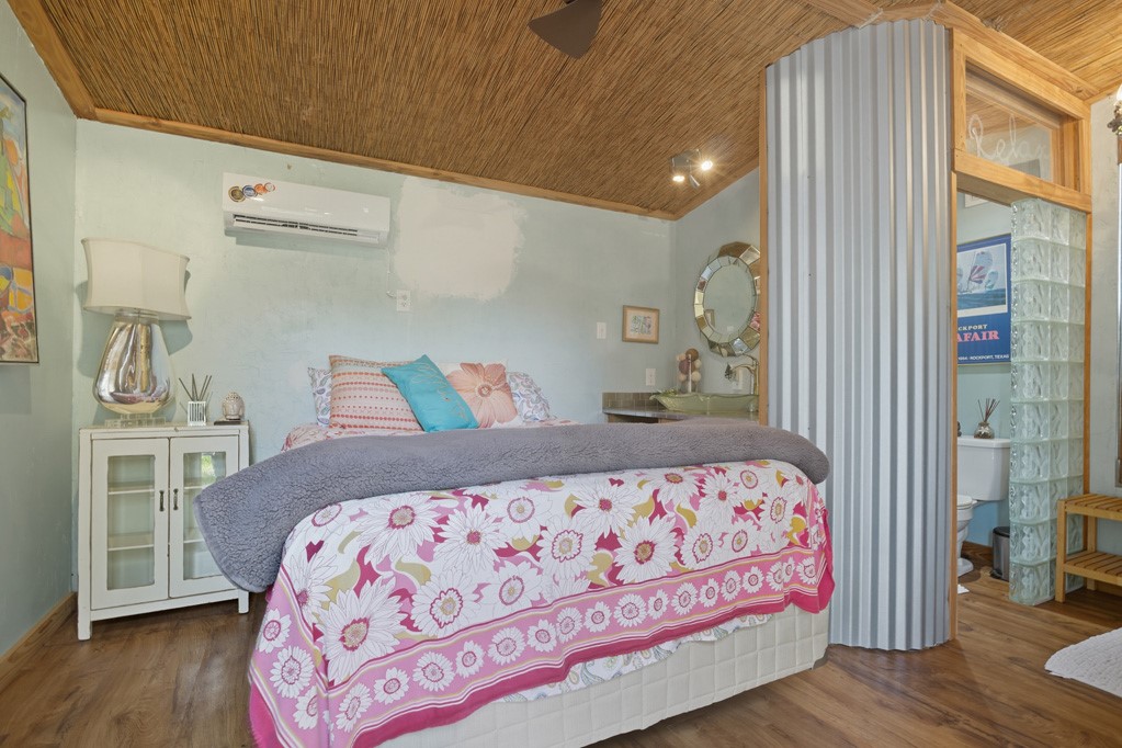 1908 Glass Avenue Rockport, TX 78382 - Photo 25 of 40 a bedroom with a bed and wooden floor