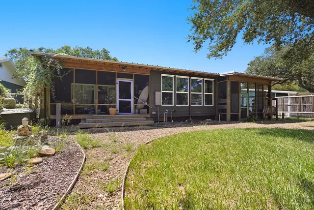 a view of a house with swimming pool and porch with furniture