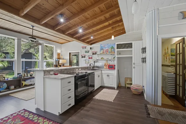 a kitchen with a stove sink and cabinets