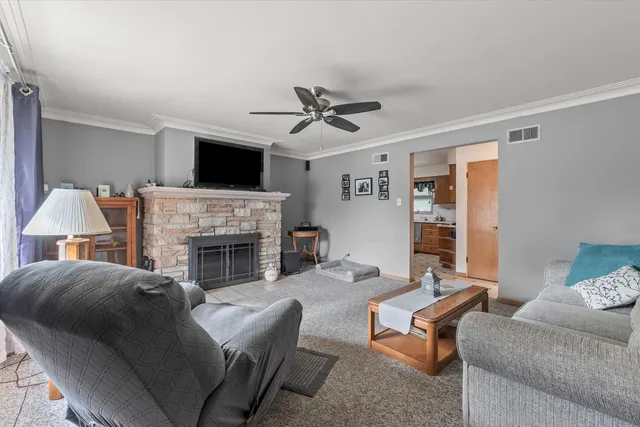 a living room with furniture a flat screen tv and a fireplace