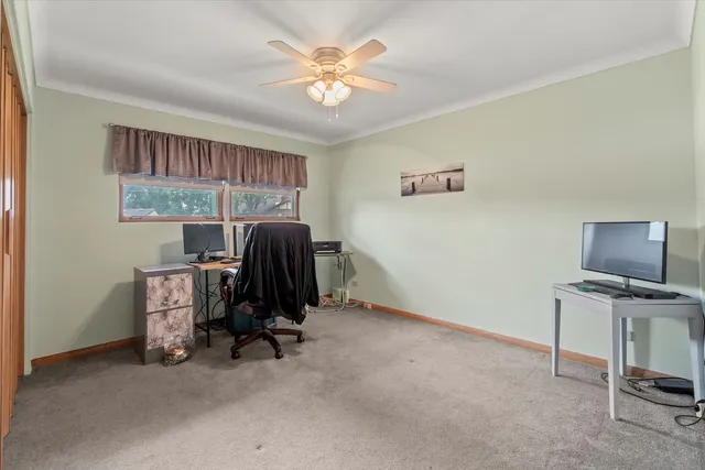 a view of workspace with a window and a ceiling fan