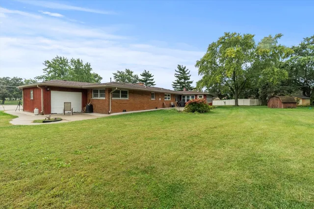 a view of a house with a backyard