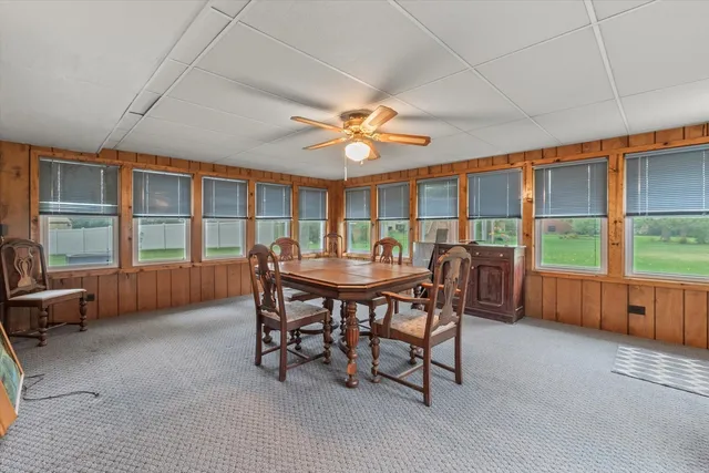 a view of a dining room with furniture window and outside view