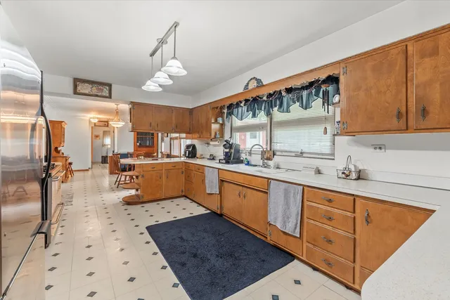 a large kitchen with stainless steel appliances kitchen island granite countertop a sink dishwasher and cabinets with wooden floor