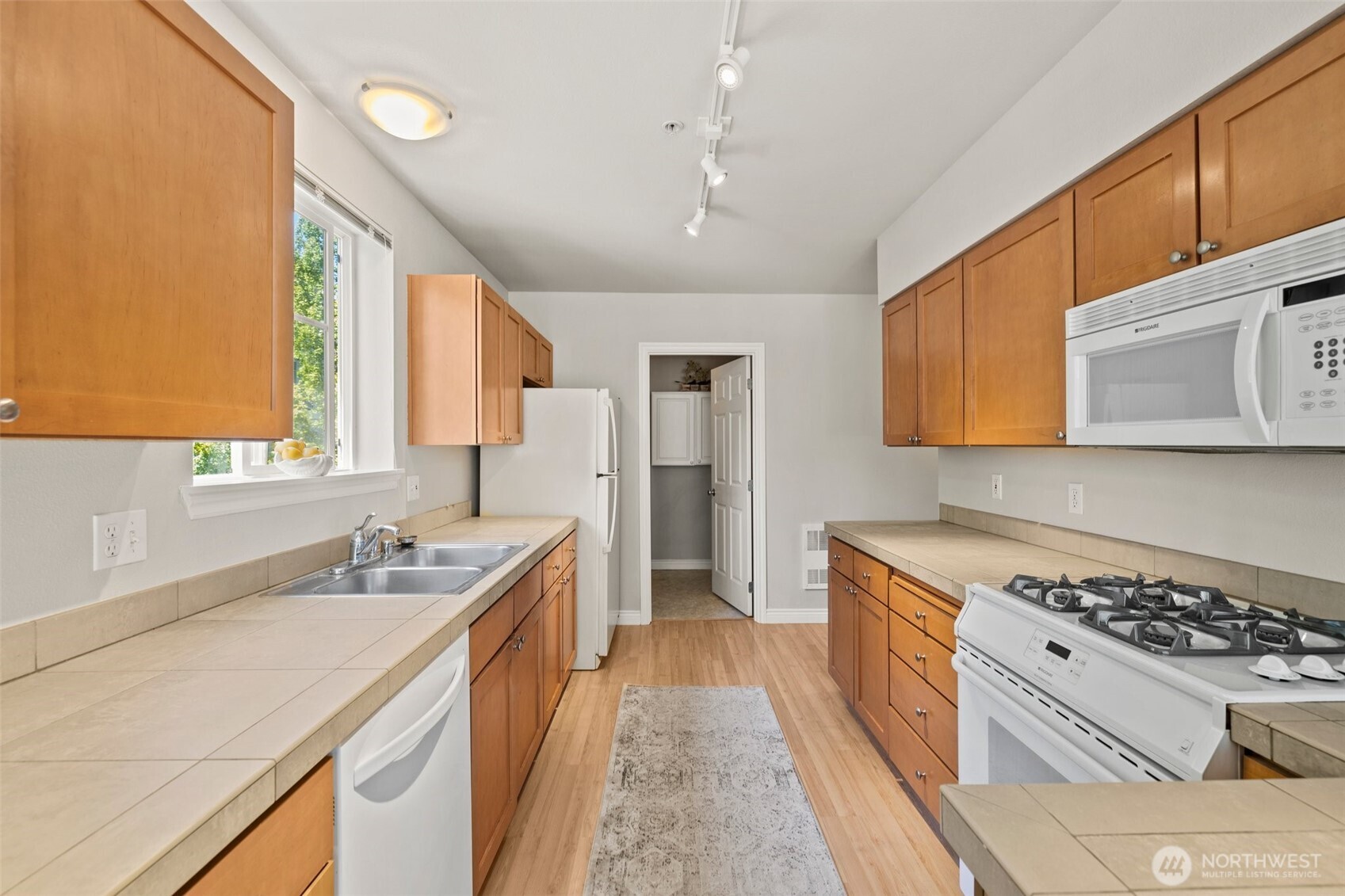 17432 Bothell Way Northeast, Unit B302 Bothell, WA 98011 - Photo 11 of 38 a kitchen with stainless steel appliances a sink stove and cabinets