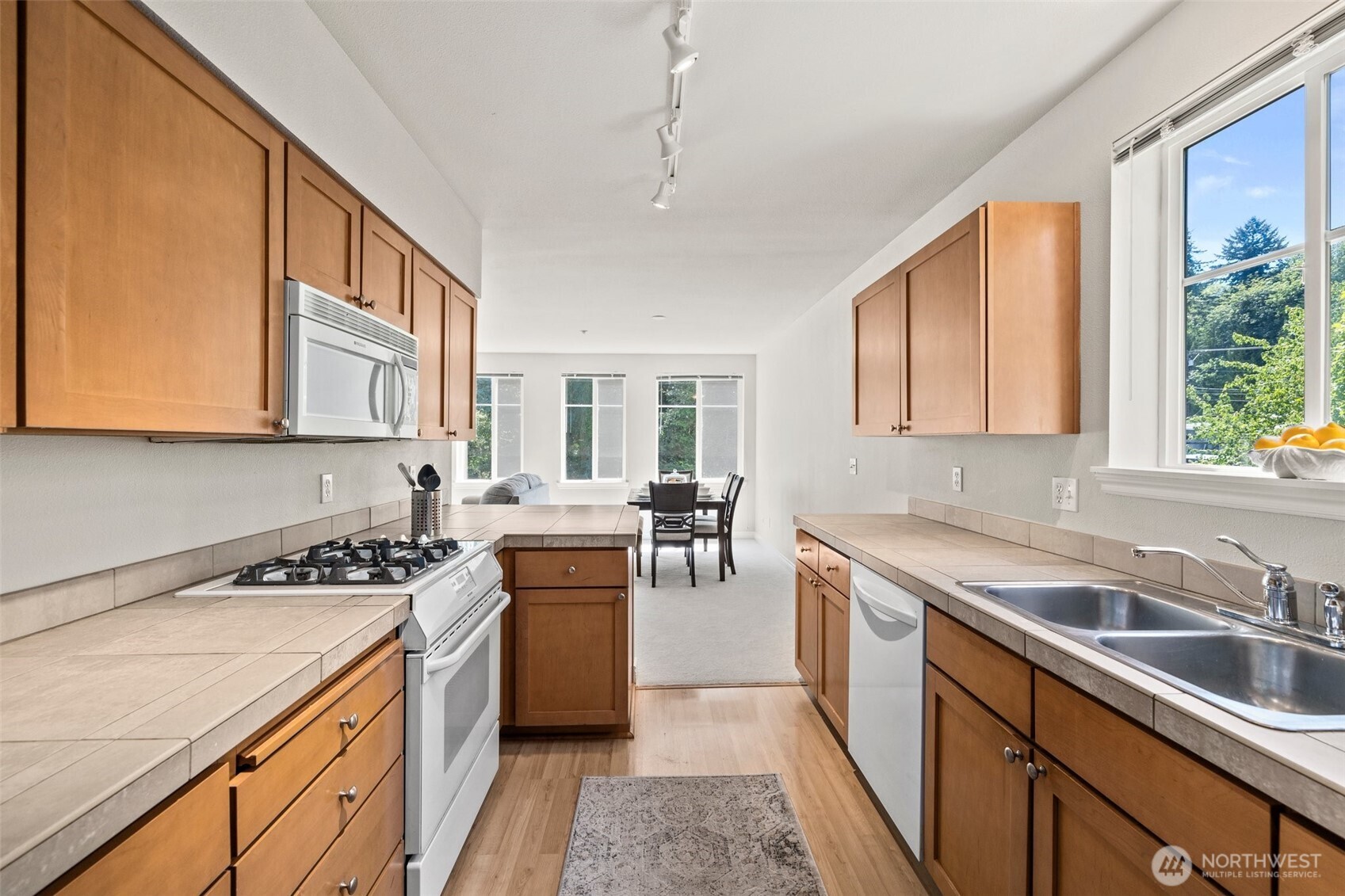 17432 Bothell Way Northeast, Unit B302 Bothell, WA 98011 - Photo 13 of 38 a kitchen with stainless steel appliances granite countertop a sink stove and cabinets