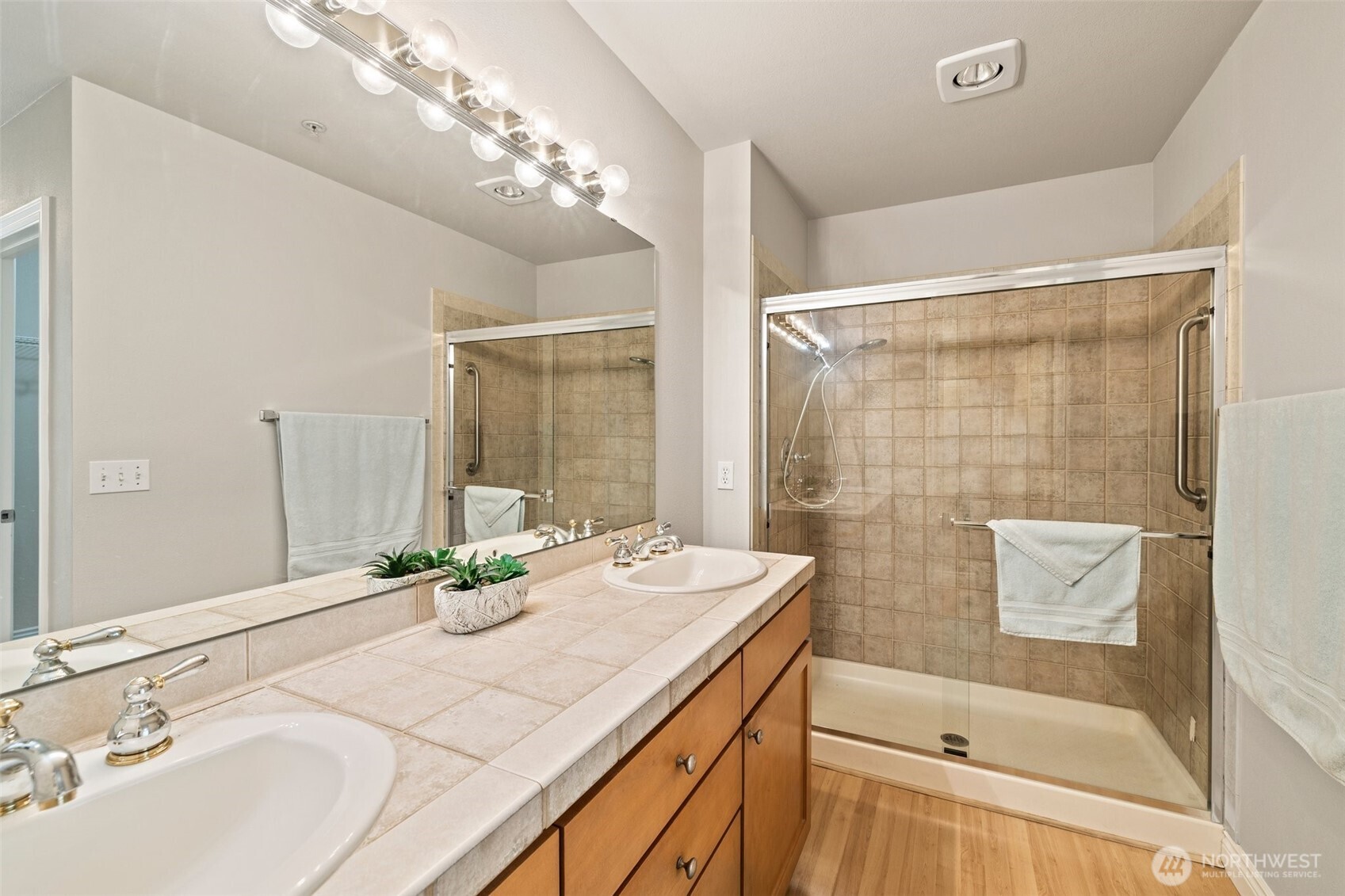 17432 Bothell Way Northeast, Unit B302 Bothell, WA 98011 - Photo 21 of 38 a bathroom with a granite countertop sink a mirror and a bathtub