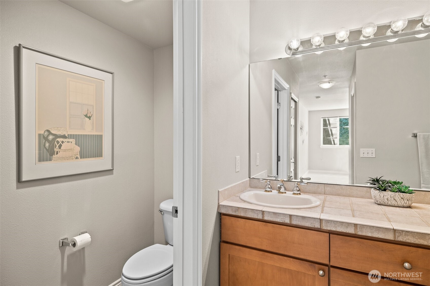 17432 Bothell Way Northeast, Unit B302 Bothell, WA 98011 - Photo 22 of 38 a bathroom with a toilet a sink and mirror