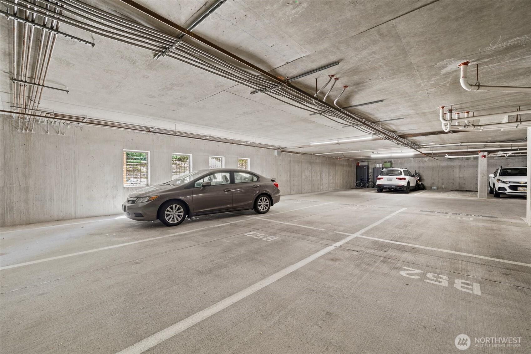 17432 Bothell Way Northeast, Unit B302 Bothell, WA 98011 - Photo 27 of 38 a view of parking garage with cars parked