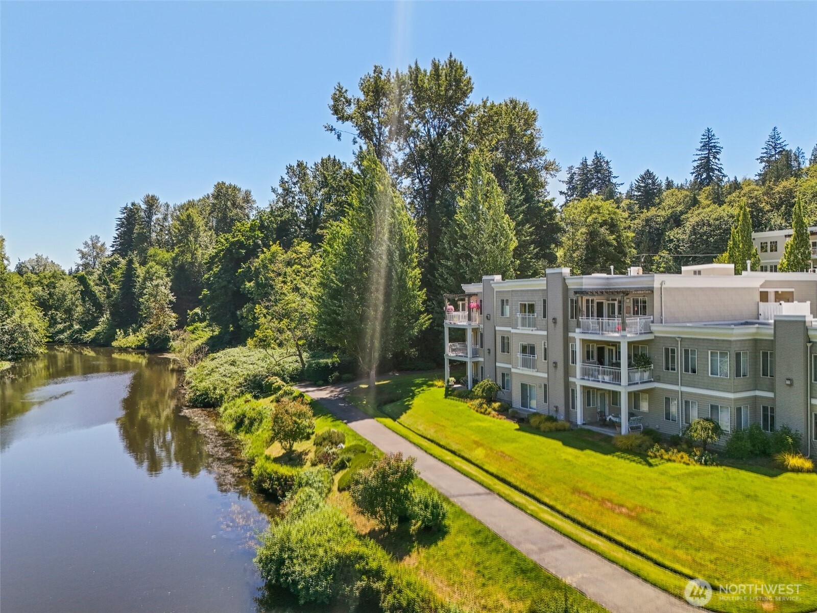 17432 Bothell Way Northeast, Unit B302 Bothell, WA 98011 - Photo 31 of 38 a view of a swimming pool with an outdoor seating and a garden