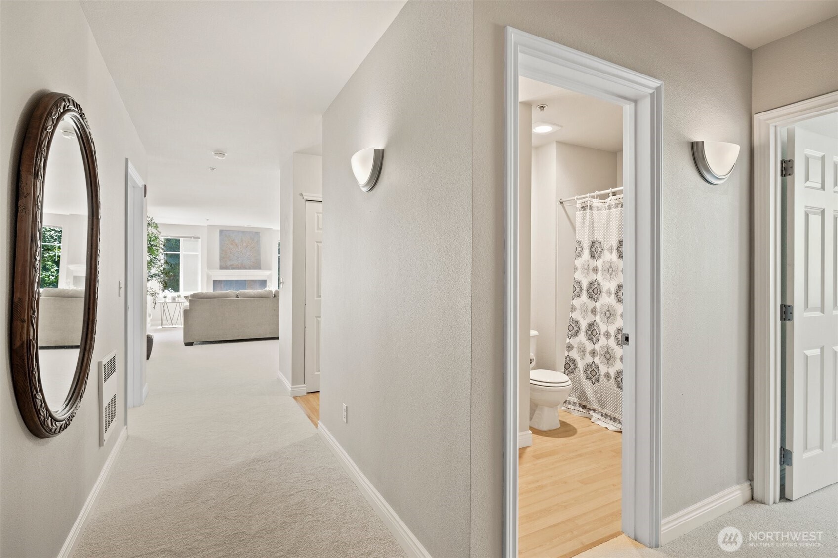 17432 Bothell Way Northeast, Unit B302 Bothell, WA 98011 - Photo 4 of 38 a view of a hallway with wooden floor and a livingroom