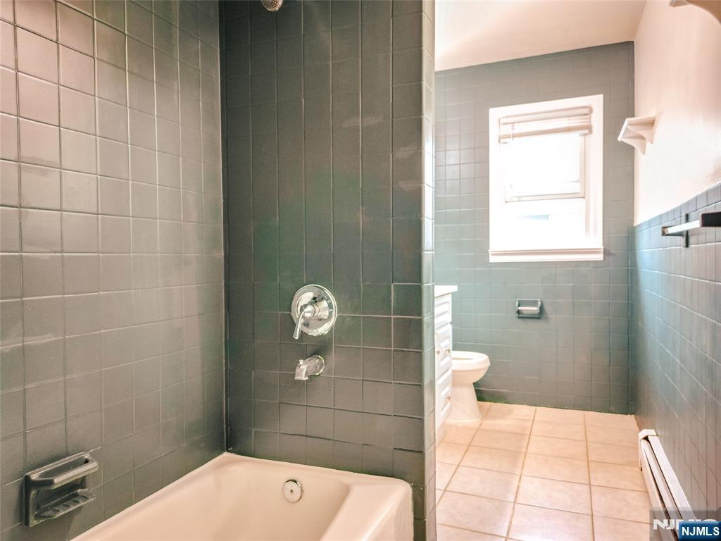 104 Eastern Way Rutherford, NJ 07070 - Photo 11 of 16 a bathroom with a sink a toilet and shower